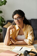 © LIGHTFIELD STUDIOS - Modern workspace for a young black woman thriving in her freelance career at home