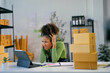 © Parichat - Stressed african american woman running a small business getting bad news on a tablet
