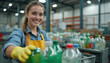 © Viktor - Smiling young woman in yellow apron, gloves sorts plastic bottles at recycling center. Works in warehouse with rows of containers filled with plastic waste. Environmental conservation, waste