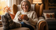 © W.O.W - Woman enjoying hot beverage in cozy armchair, autumn season warmth concept. Relaxing at home during fall.