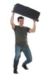© 1STunningART - Furious and irritated young man traveler lifting and throwing away his travel luggage. Displeased guy has issues with his baggage, full length portrait isolated on transparent background