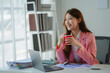 © PaeGAG - Businesswoman drinking coffee enjoying break from work in modern office