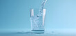 © Muhammad - Crystal clear water pouring into a pristine glass creating refreshing bubbles and dynamic splashes against a vibrant blue backdrop, perfect for health and wellness campaigns.