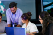 © ultramansk - A data science team collaborates on a machine learning workflow. The lead analyst points out a data pipeline issue on a laptop, mentoring junior data scientists on the project.