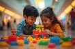 © Viktor - Two Indian kids, brother, sister, happily play with colorful plastic blocks, building structures together. Smiling faces show joy, concentration in learning through play. Scene captures moment of