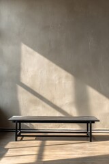 Wall Mural - Minimalist interior with black bench and sunlit wall in modern living space