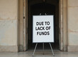 © Viktor - Sign reads Due to Lack of Funds placed outside building entrance. Educational program closure impacts student learning, future opportunities. Financial challenge affects community services, resource