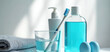 © Viktor - Bathroom counter essentials for oral hygiene toothbrush in glass with water, minty mouthwash bottle, dispenser, and folded towels. Daily routine kit promotes clean teeth, fresh breath, healthy gums.
