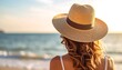 © Kusuma - Woman in sunhat on beach at sunset