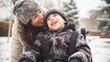 © DEIB Visuals - Happy candid mother and disabled child in a wheelchair spending time together in a park playground in the snow. Supportive inclusive family with handicapped children. Inclusion & diversity, Winter