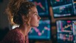 © Farah - Determined young woman analyzes complex financial data on multiple glowing monitors, seeking market insights for profitable investment decisions