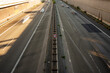 Urban highway with central 100 speed limit sign at golden hour