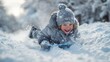 © Snowstudio - Happy child sledding down snowy hill in winter landscape