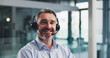 © peopleimages.com - Headset, happy and portrait of businessman in office with communication, contact us or crm. Smile, mic and mature male technical support consultant from London with customer service in workplace.