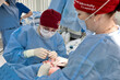 © Georgii - Surgical team performing a delicate procedure in a sterile operating room