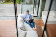 © Westend61 - Freelancer working on laptop in living room at home