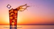 © Revisio - Iced sweet tea splash with flying ice cube and amber droplets, sunset gradient background