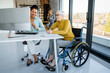 © NDABCREATIVITY - A diverse group of young professionals, including senior businesswomen entrepreneur in a wheelchair