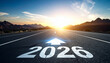 © photostockatinat - Looking ahead to 2026: A road to future vision.  The image features an arrow pointing the road towards 2026 with a beautiful sky and mountains in background.
