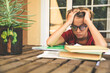 © Fabio Principe - Tired student doing homework at home sitting outdoor with school books and newspaper. Boy weary due to heavy study. Kid asleep on the copybook after long tasks. Youth, education and fatigue concept.