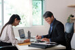 © Natee Meepian - Car Dealership. A friendly consultation between a client and a salesperson.