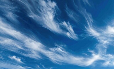 Wall Mural - Wispy cirrus clouds drift gracefully across a vibrant blue sky, creating a serene and ethereal atmospheric scene