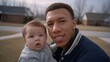© liliyabatyrova - Young man holds baby outdoors during a sunny afternoon in a suburban neighborhood