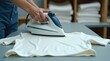 © Lesia - Premium cinematic shot of cotton t-shirt on ironing board, hot iron removing wrinkles, fabric textures crisp and detailed, steam glowing, blurred textile workshop background with neatly stacked fabric