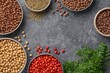 © Rizvan - Nutrition and diet focus on wholesome eating, plant-based protein options. Uncooked legumes assortment including chickpeas, various lentils, beans, and bulgur. Aerial perspective flat arrangement.