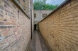 The narrow enclosed walkway guiding to the Porter's Lodge and First Court of the college grounds.