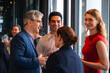 © Jack Tamrong - Group of business people drinking and chatting together on business meeting party