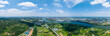 Suizhou City China shows a wide river flowing through green landscapes towards the city buildings under a bright blue sky with fluffy clouds.