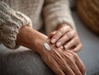 © Yuliya - Elderly woman hand with cream on skin