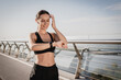 © InsideCreativeHouse - Fit active woman in sportswear looking on smartwatch after running rate the pulse accounting calories. Outdoor sports in the morning with modern technologies, copy space.
