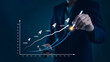 © khunkornStudio - ROI, analytics Manager visualizes monthly KPI line in a workspace to optimize sales, revenue, and performance, informing business metrics and investors. concept data driven growth strategy.