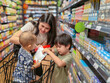 © Apichat - woman and two children are shopping in a grocery store