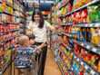 © Apichat - woman with two children in a grocery store