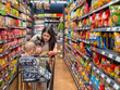 © Apichat - woman and her two children are shopping in a grocery store