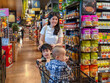 © Apichat - woman and two children are shopping in a grocery store