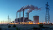© rahul - A coal power plant with smoke stacks at dusk with a blue sky