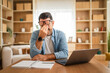 © Miljan Živković - Tired businessman rubbing eyes while working from home