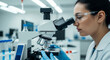 © designermetin - Female scientist analyzing slide with microscope in laboratory research facility for medical diagnostics study