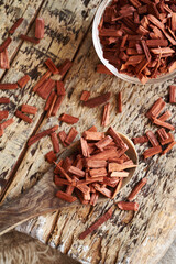Wall Mural - Pieces of red sandalwood on a wooden spoon