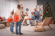 © Pixel-Shot - Little children with gifts for their family at home on Christmas eve, back view