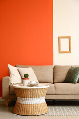 Wall Mural - Comfortable sofa and wicker coffee table in interior of living room, closeup