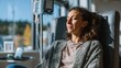 © Alex Photography - A serene woman relaxes in a comfortable chair while receiving an IV therapy treatment in a sunlit medical setting.