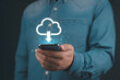 © Hriday - Cloud Connection: A person holds a smartphone displaying a cloud icon, symbolizing modern cloud technology and digital connectivity.