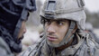 © catocala - Young Hispanic soldier engaging in a serious conversation during winter training exercise in a remote location