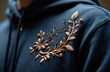 © miss irine - Detailed illustration of dark navy hoodie featuring exquisite gold thread embroidery with floral, leaf motifs. Textured fabric adds depth. Chic, stylish garment embodies craftsmanship, unique design,