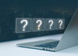 © wanchai peatoo - Laptop with glowing question mark icons, concept of online search, digital problem solving, decision making, uncertainty, information technology, brainstorming, innovation, and knowledge discovery.